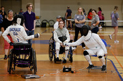 Participants try their hand at wheelchair fencing.
