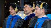 Immunology graduates Zhen Tang, Ph.D., left, and Cong Xing, Ph.D., right, proudly pose for a photo with Nan Yan, Ph.D., Professor of Immunology and Microbiology.