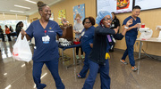 Certified Medical Office Assistant Marilyn Lowery (left) and Anesthesia Technician Latasha Dixon have fun during an impromptu dance at UT Southwestern’s Juneteenth Celebration, which took place a few days in advance of the national holiday. The UTSW event featured cuisine that represented staple food served at Juneteenth celebrations across the state within the African American community. All UTSW staff, faculty, and students were invited.