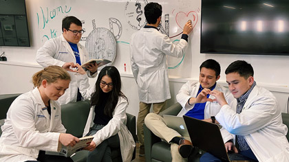 People in lab coats making heart shapes in various ways