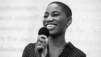 Woman holding microphone and smiling