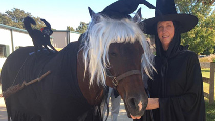 Woman and horse, both dressed as witches