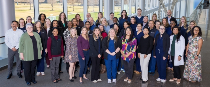 large group of nursing staff standing in UTSW atrium