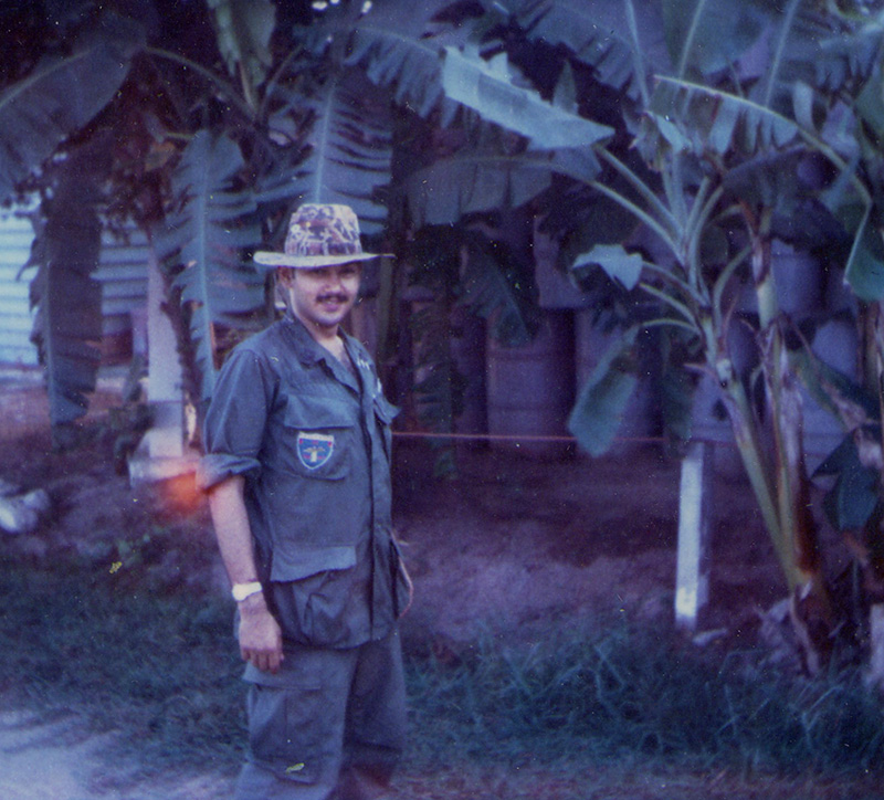 Spc. Idris, wearing a jungle hat, relaxes on base.