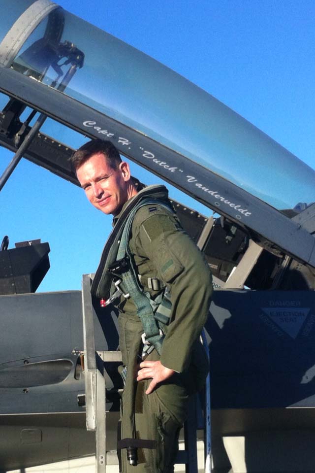 Maj. Vanderveldt, stands outside an F-16 aircraft.