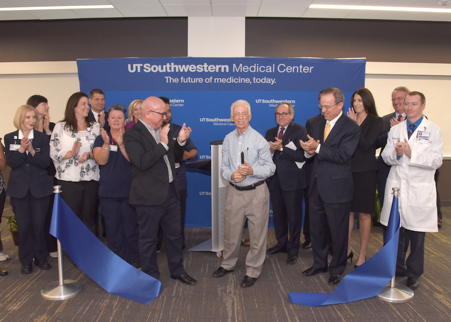 Many people applauding as the ribbon is cut on the new West Campus Building 3