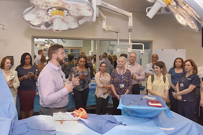 Matthew Kosemund explains to a tour group how the Simulation Center works