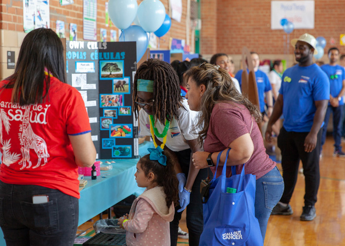 Line of participants visiting different exhibit booths