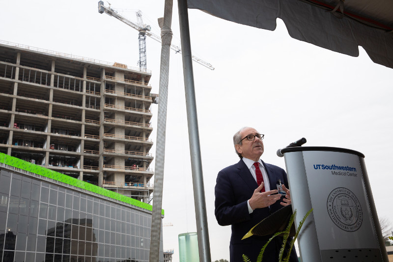 Dr. Podolsky at podium speaking at milestone ceremony