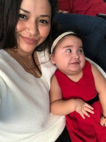 Carmen Mejia holds her daughter Elizabeth, whose metabolic disorder causes her frequent seizures.