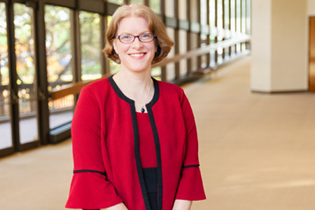 Woman in red shirt and glasses smiling