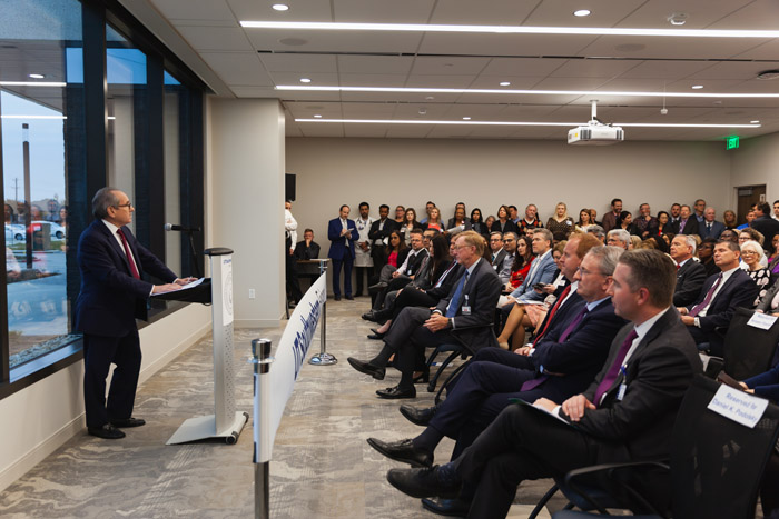 Man speaking to large room of people