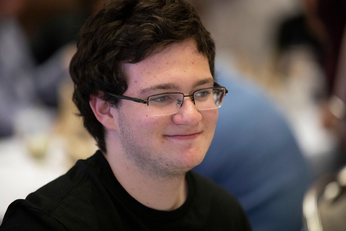 Man with glasses and black shirt