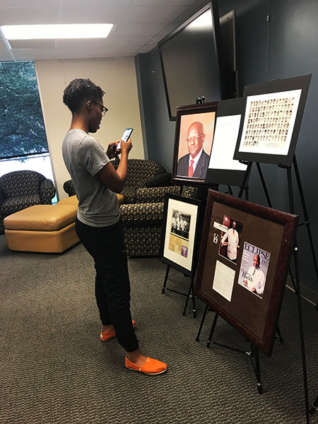 Students view display honoring Dr. Lee Henry