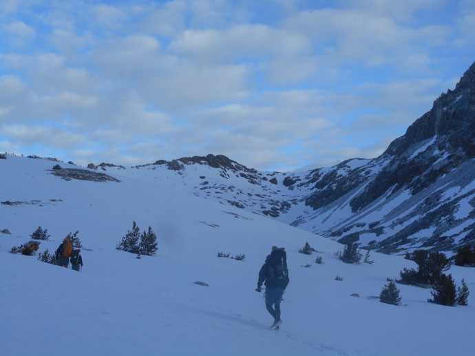 Man in snow approaching pass