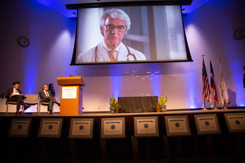 Video showing a doctor playing above a large stage