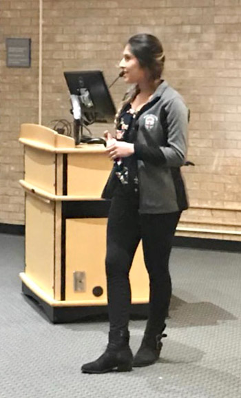 Woman standing next to podium