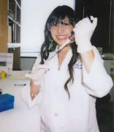 Young woman in lab coat working in lab