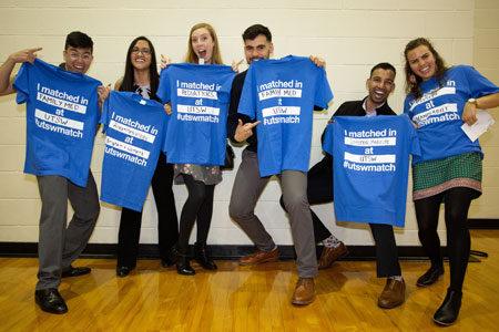 UTSW Med students holding match day t shirts