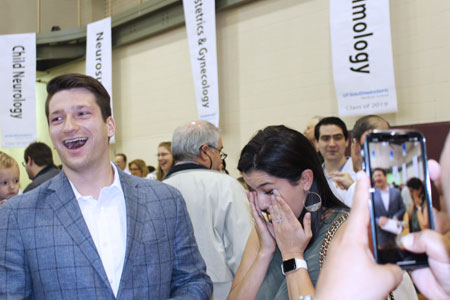 Students reacting happily after opening letters