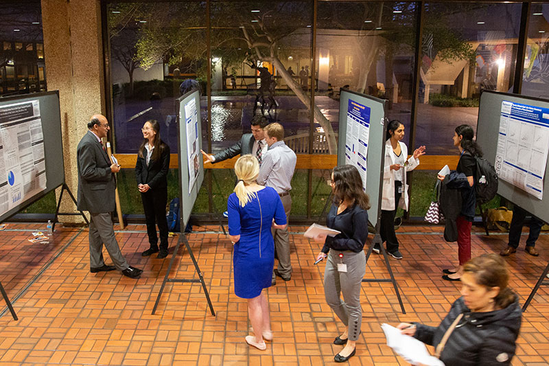 photo of exhibit hall with posters and onlookers