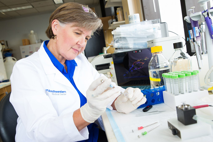 Woman working with test tubes wearing a lab coat