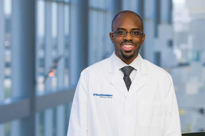 Man with glasses, goatee, wearing a lab coat