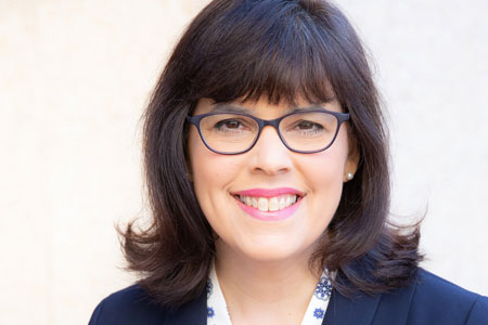 Woman with dark hair and glasses