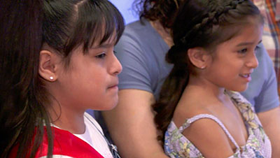 Sisters look on at festivities