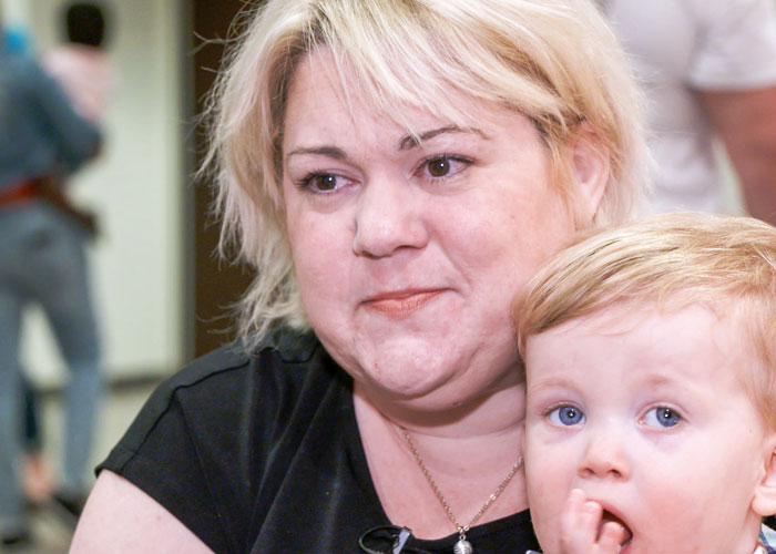 Mother holding toddler in lap