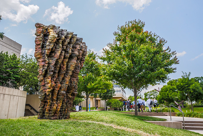 Sculpture on grassy hill in plaza