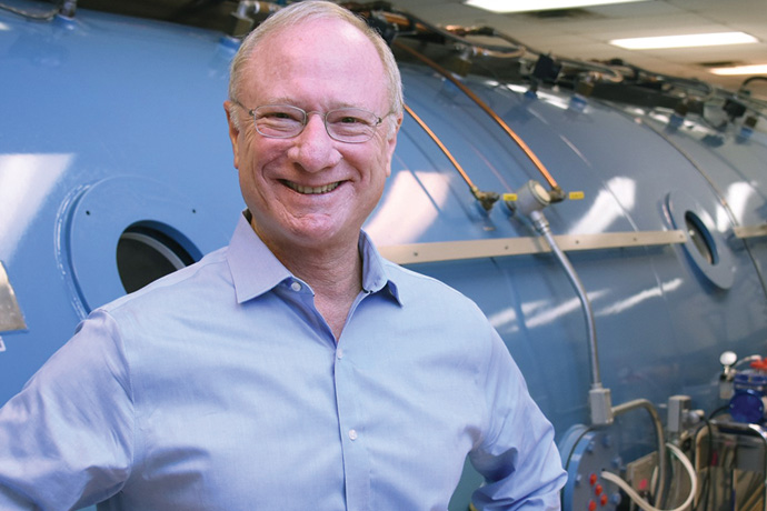 Man standing in front of large cylindrical machine