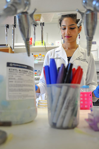 Decorative image of Dr. Sreelatha in the lab