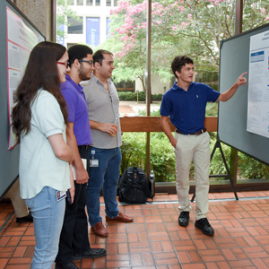 Students reviewing mounted lab presentations