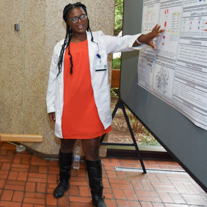 UTSW lab member pointing to presentation