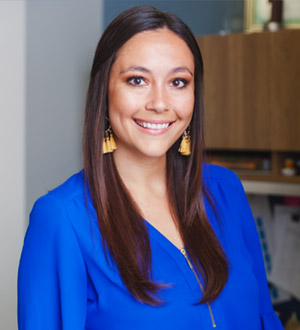 Woman with long dark hair, blue blouse