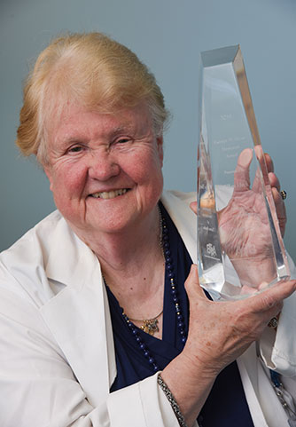 Ellen Heck holding her Hyatt Memorial Award