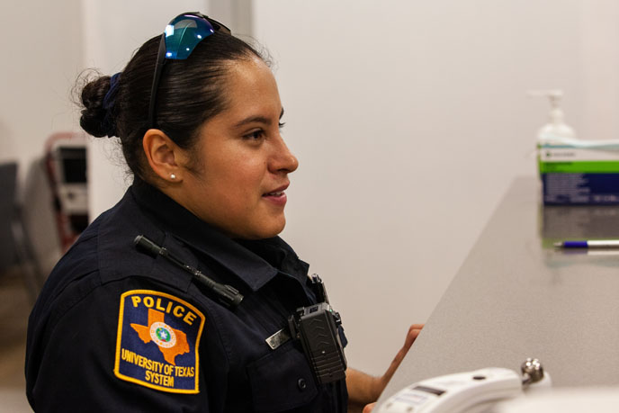 Officer wearing uniform and sunglasses on her head in a hospital room