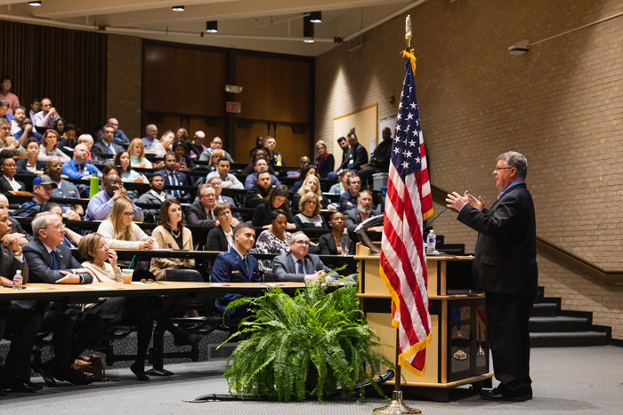 Man at podium speaking to a crowd