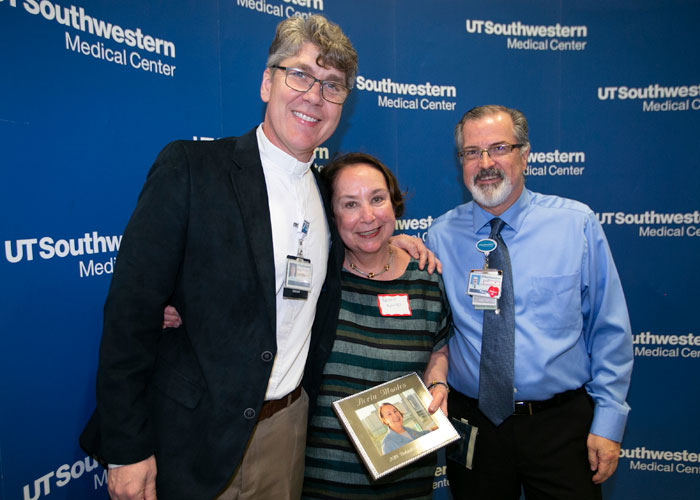Volunteer of the Year award winner Berta Montes (center) with the Rev. John O&rsquo;Neal, Director of Chaplain Services, and Scott Glover, Administrative Assistant for Volunteer Services.