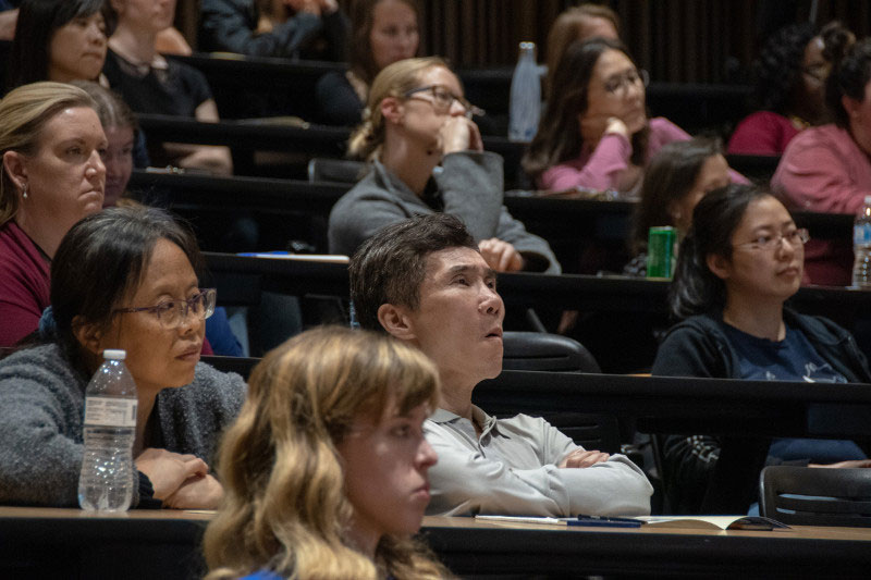 Diverse audience listening intently