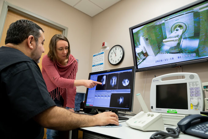 Dr. Henning and Salvador Peña, MRI Technologist, review images from the 7T