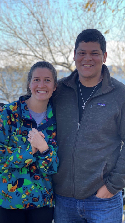 Man and woman smiling, woman wearing ring