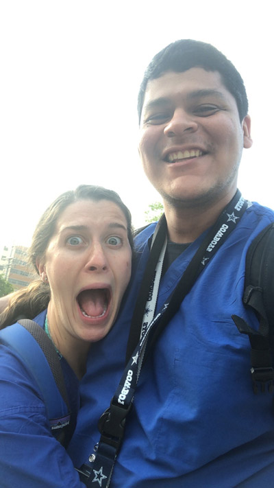 Man smiling and woman with mouth agape and eyes wide