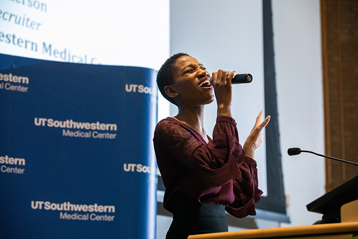 Woman singing into a microphone