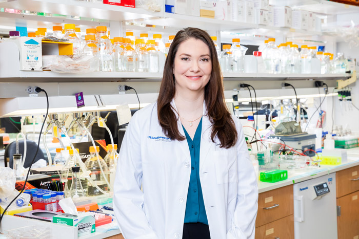 Woman in lab coat standing in lab