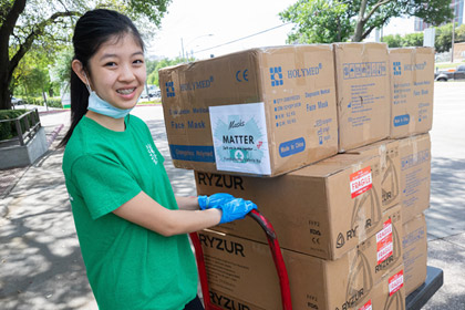 A young lady with a green shirt and mask