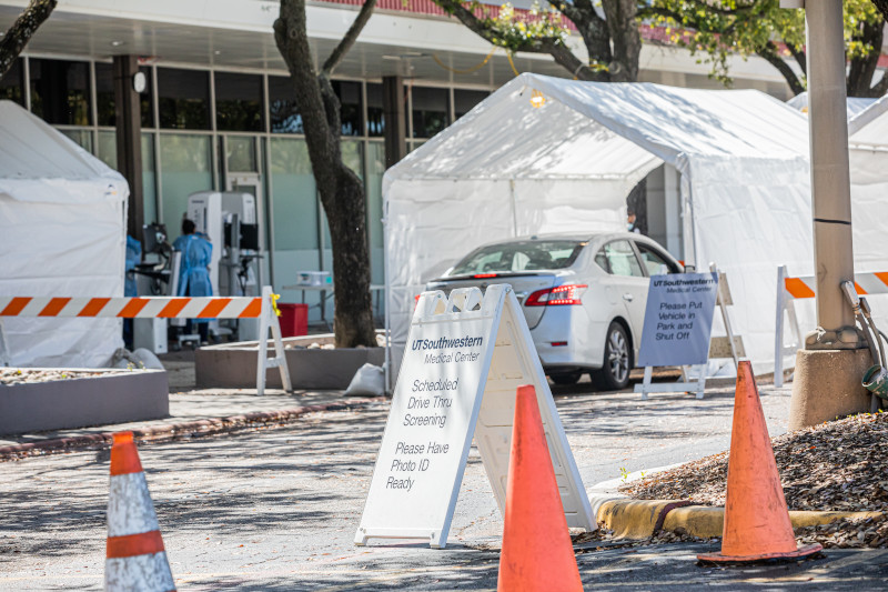 Car parked under white tent surrounded by cones