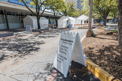 Building with tents and sign out front