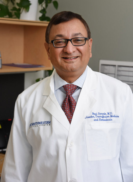 Man with glasses and white lab coat